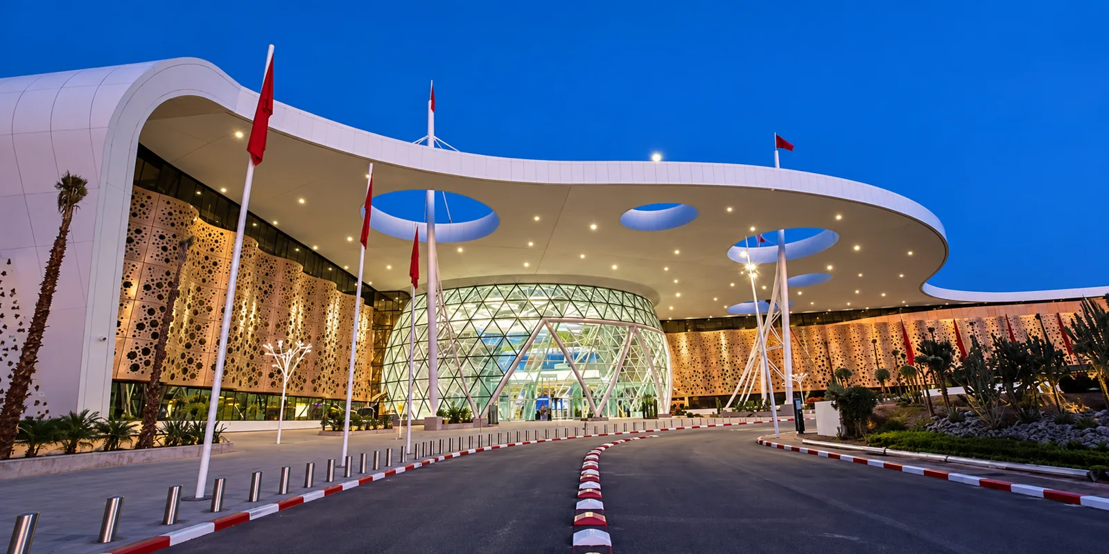 Illuminated Marrakech airport terminal and entrance at dusk