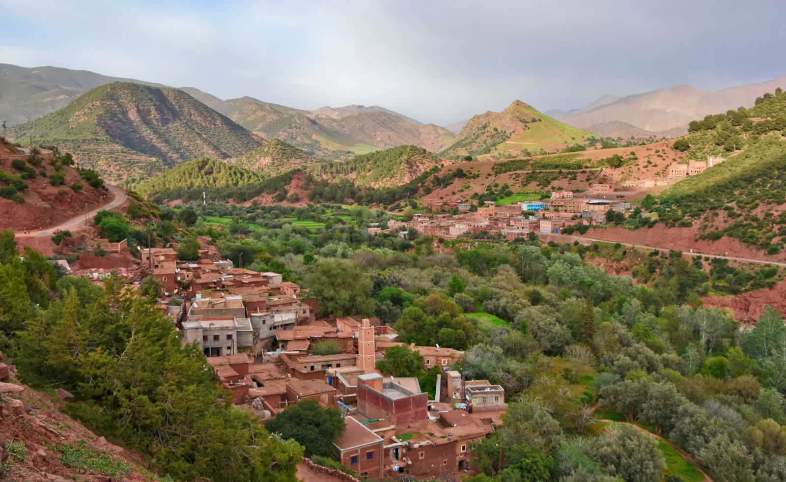 Hillside villages and a minaret overlooking a green valley near Imlil and Asni