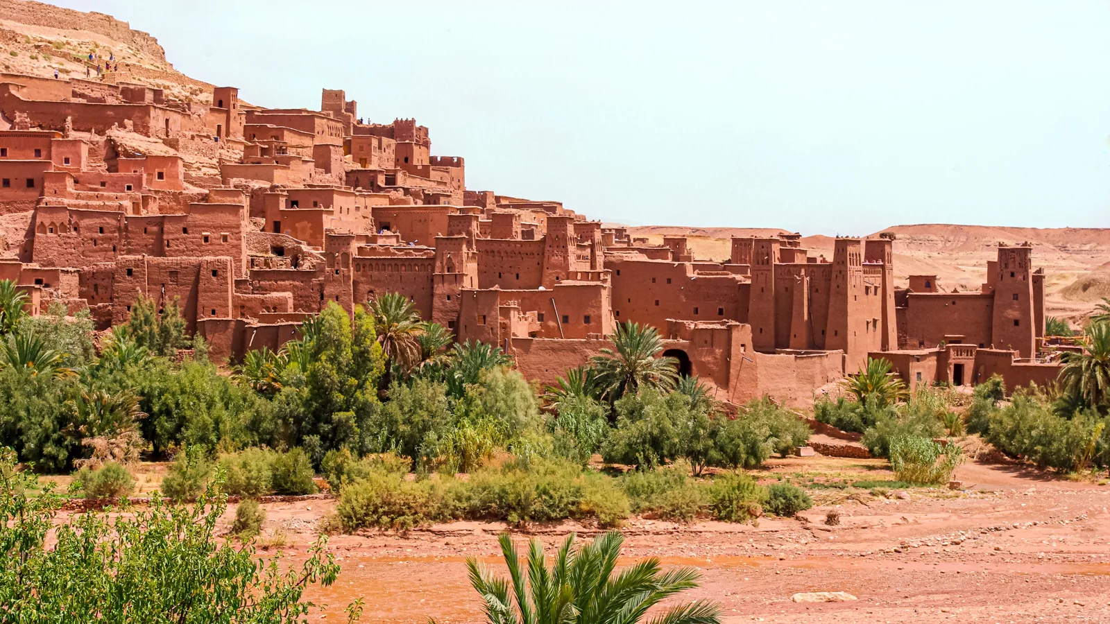 Earthen kasbah buildings and palm trees at Ait-Ben-Haddou