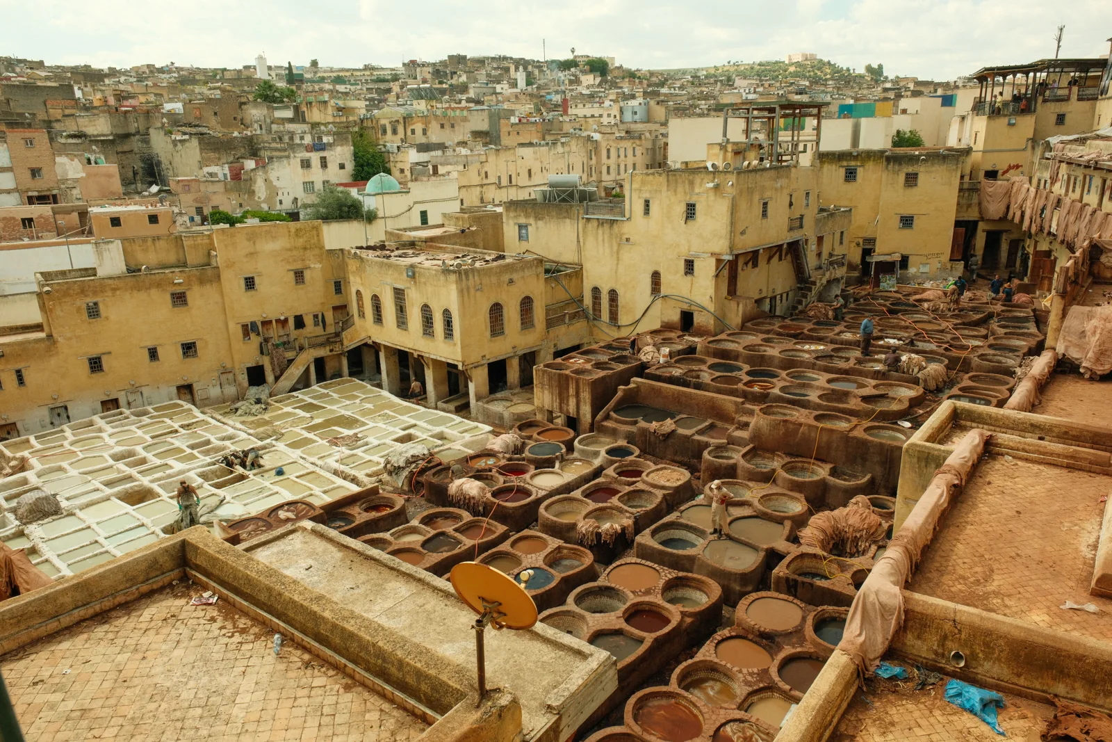 Traditional leather tanning vats surrounded by buildings in the Fes medina