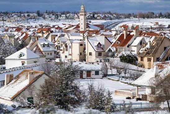 Snow-covered rooftops and a minaret in Ifran